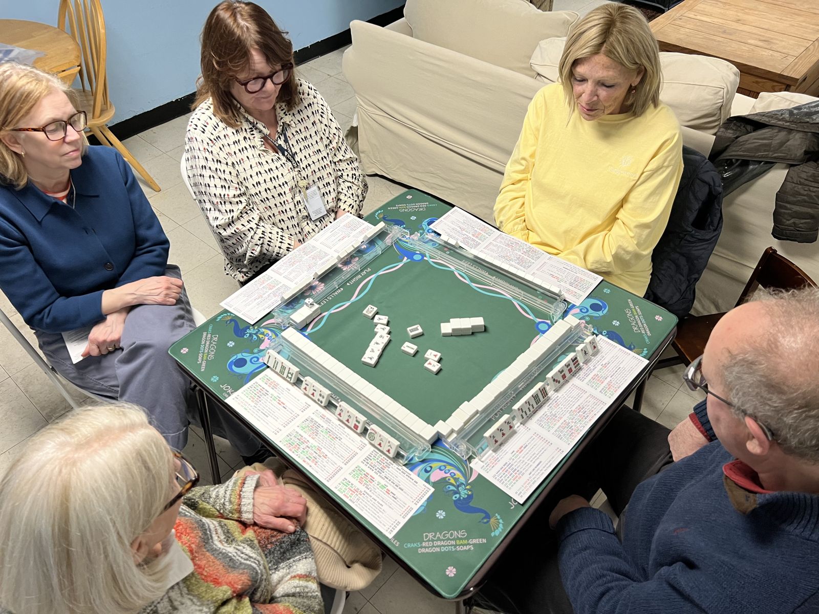A small group class in session, one table of players mid-game